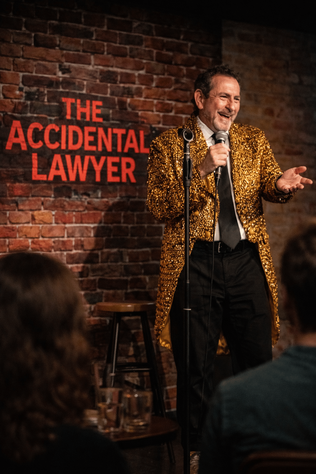 Accidental Lawyer on stage with Accidental Lawyer behind him.png